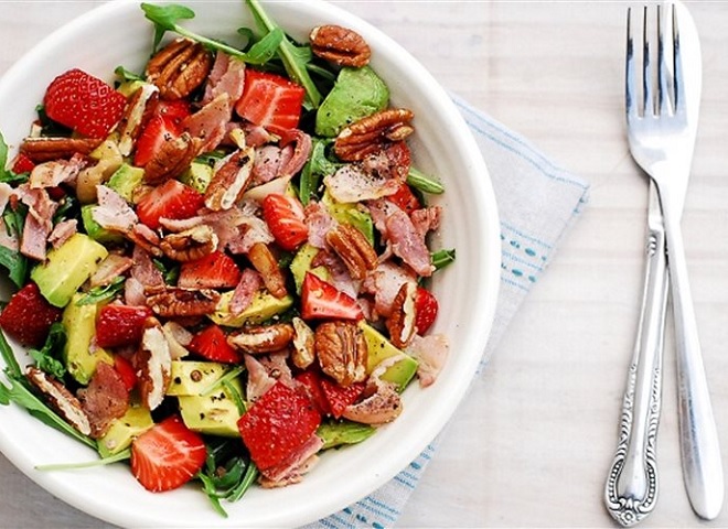 The finished salad with bacon and strawberries stands out in color