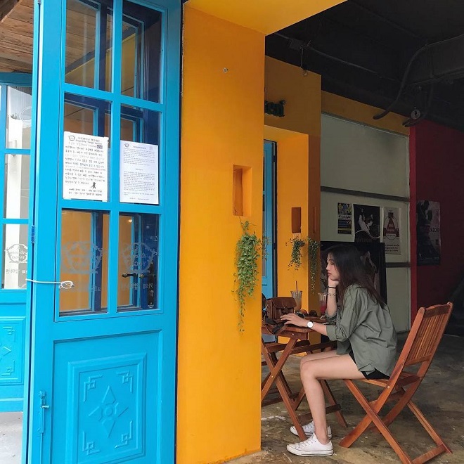 Cửa xanh, tường vàng là nét màu chủ đạo của Almacen Cafe